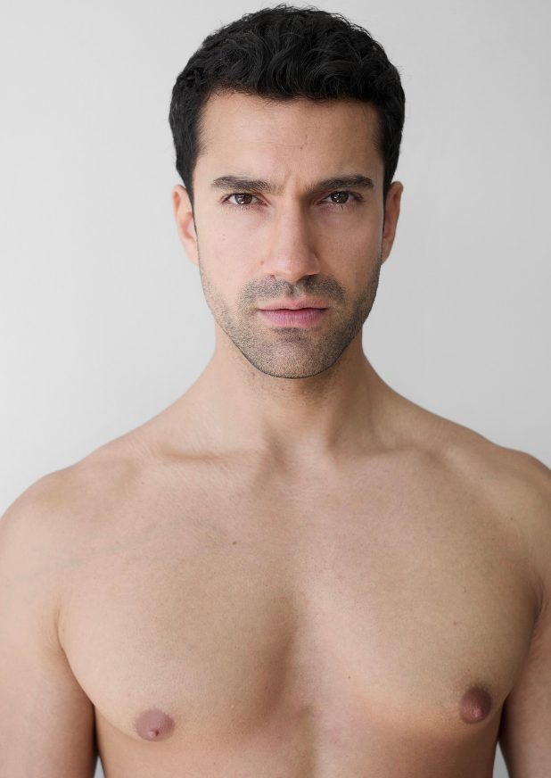 Example digital of a male model: natural light, plain background, no filters