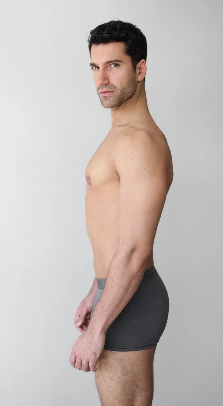 Half-body digital of a male model, side view, plain background