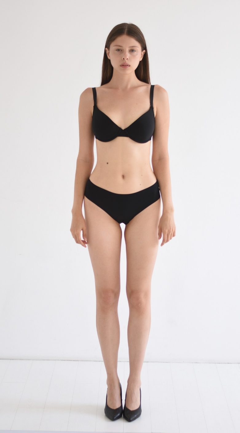 Full-body digital of a female model, front view, head to toe against a plain wall